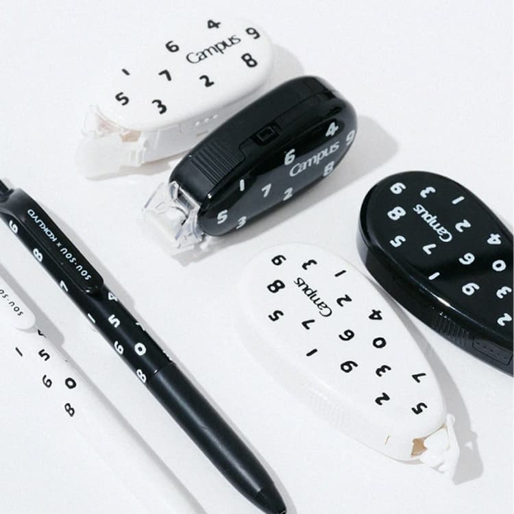 Kokuyo Campus stationery set featuring a black pen and various white and black pencil cases with numeric patterns.
