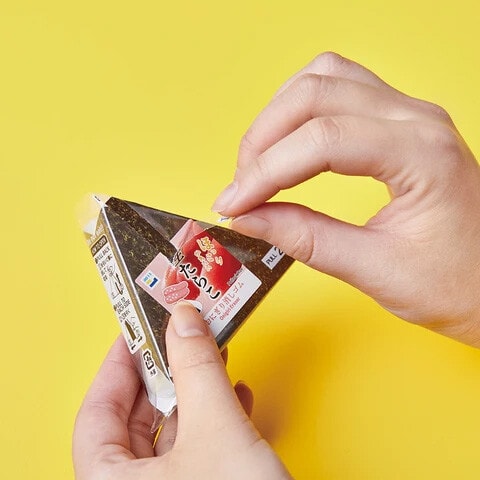 Person opening a realistic onigiri stationery by Kingjim